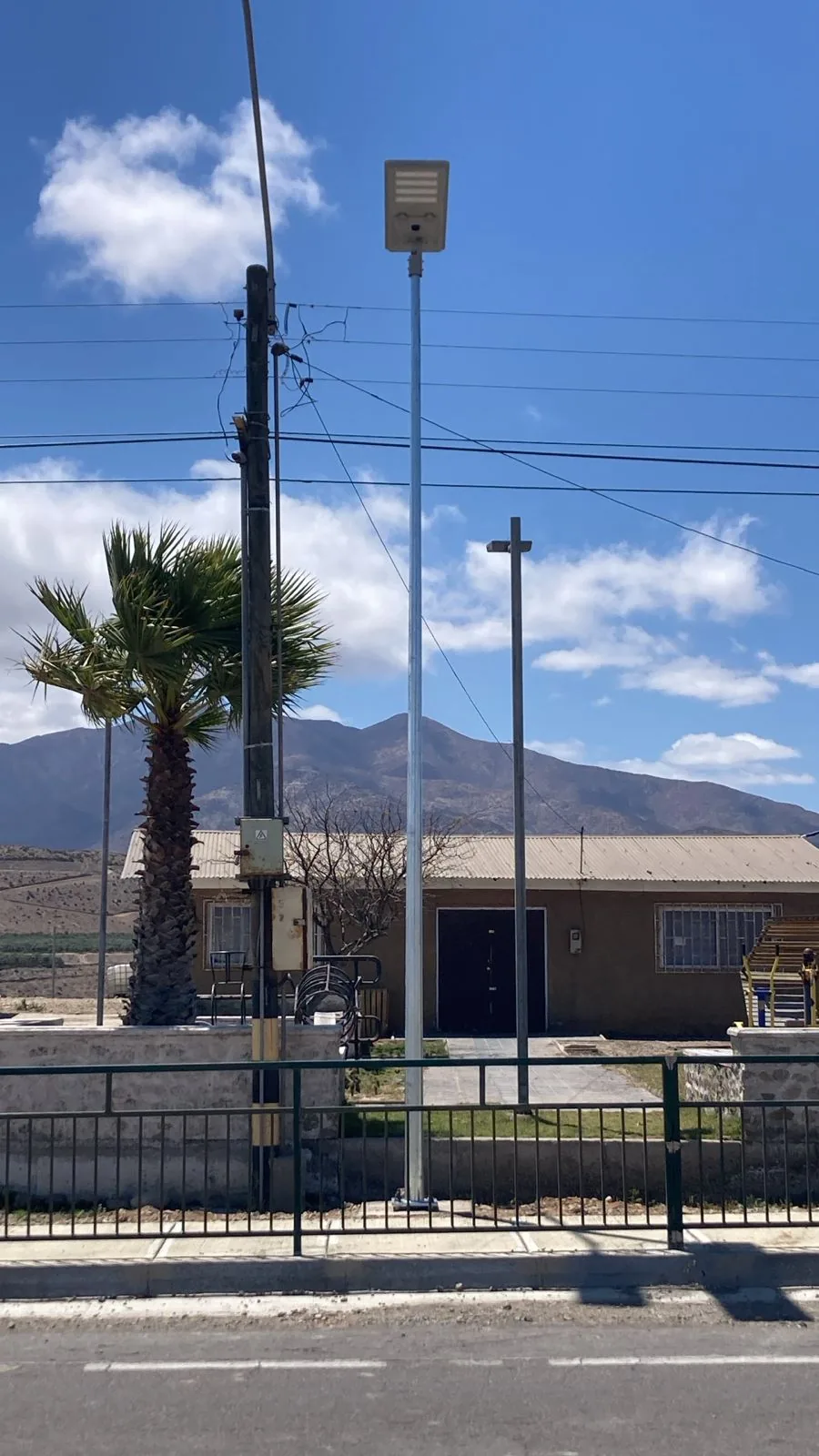 An all-in-one solar street light on a pole in a village without grid electricity