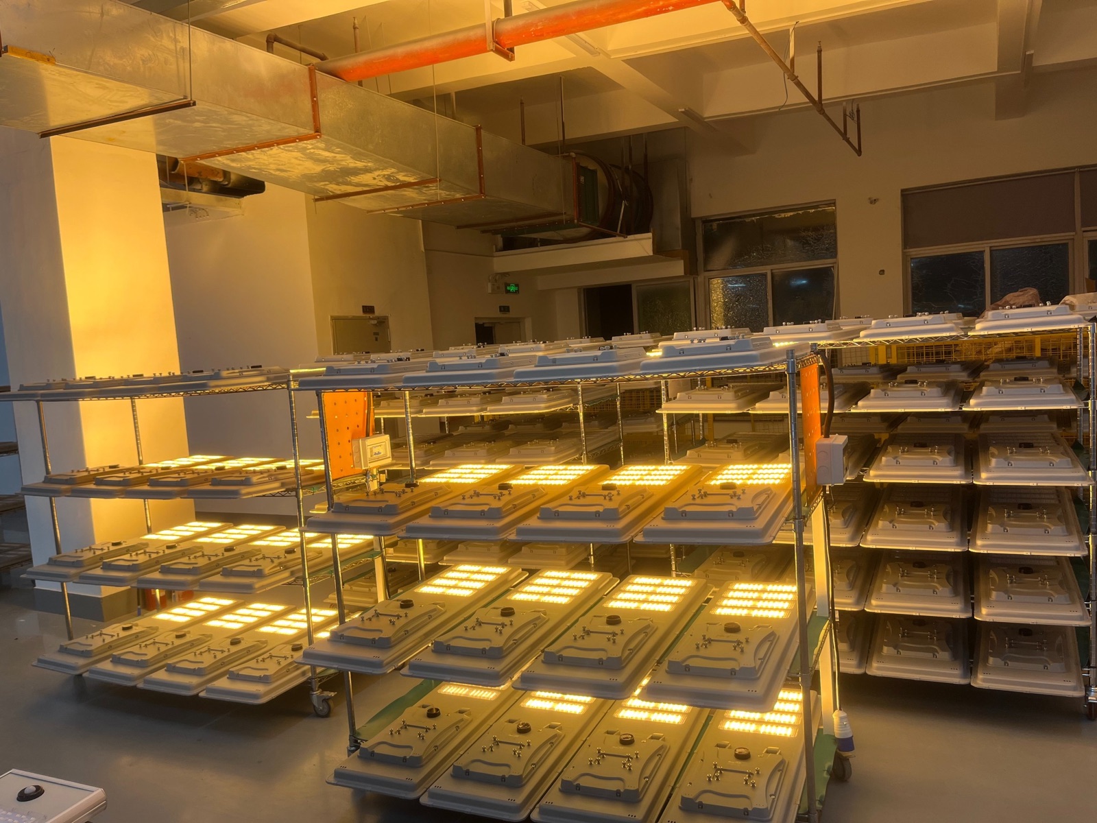 Solar LED street lights on racks running a 24-hour aging test in the Shenzhen factory